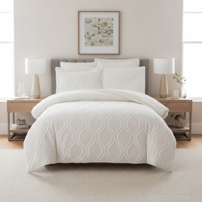 White textured bedcover and pillow styled on bed
