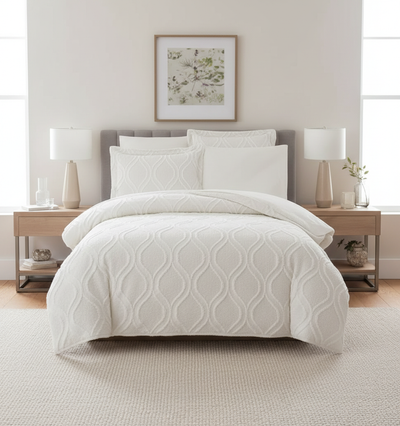 White textured bedcover and pillow styled on bed